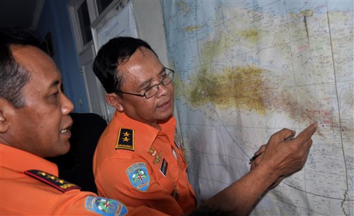 National Search And Rescue Agency (BASARNAS) chief F. Henry Bambang Soelistyo, left, looks at a map with Air Vice Marshal Sudipo Handoyo during a search operation for the missing Trigana Air Service flight at Sentani airport in Jayapura, Papua province, Indonesia, Monday, Aug. 17, 2015. Rescuers are making their way into the rugged mountains of Indonesia's easternmost province of Papua, where the airliner carrying 54 people went missing in bad weather Sunday. (AP Photo/Alfian)