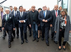 French Prime Minister Manuel Valls, 2nd left, walks along with French Interior Minister Bernard Cazeneuve, left, and European commissioners Frans Timmermans, 3rd right, and Dimitris Avramopoulos, 2nd right, as they visit the Channel tunnel site in Calais, northern France, Monday, Aug. 1st, 2015. (Denis Charlet/Pool Photo via AP)
