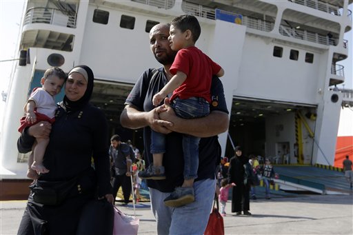 A family arrives from the northeastern Greek island of Lesbos to the Athens port of Piraeus, Friday, Sept. 4, 2015. About 2,500 people arrived on the ferry Eleftherios Venizelos. (AP Photo/Thanassis Stavrakis)