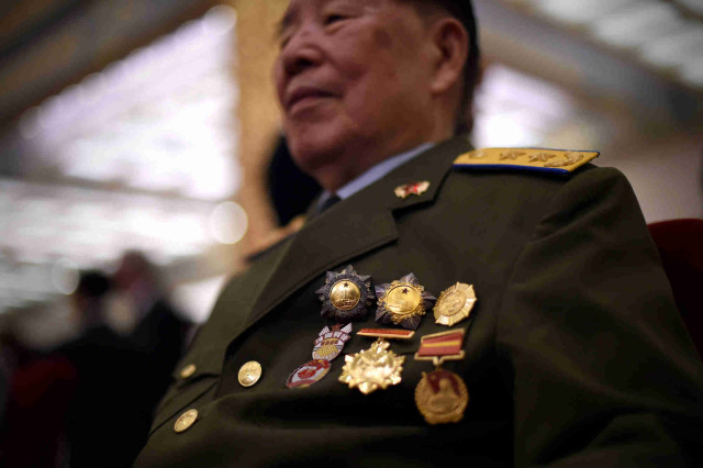 A World War II veteran decorated with medals attends an awards ceremony marking the 70th anniversary of the end of World War II, at the Great Hall of the People in Beijing on September 2, 2015. China is preparing to hold a massive military parade on September 3, to commemorate the 70th anniversary of Japan's defeat in 1945 and the end of World War II.   ( AFP Photo/Wang Zhao)