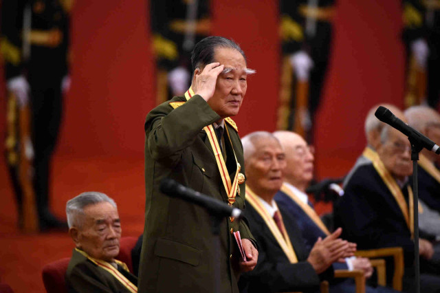 A World War II veteran salutes after giving a speech during an awards ceremony marking the 70th anniversary of the end of World War II, at the Great Hall of the People in Beijing on September 2, 2015. China is preparing to hold a massive military parade on September 3, to commemorate the 70th anniversary of Japan's defeat in 1945 and the end of World War II.   (AFP photo/ Wang Zhao)
