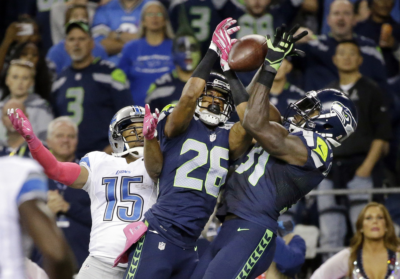 Seattle Seahawks strong safety Kam Chancellor, right, and cornerback Cary Williams (26) break up a pass intended for Detroit Lions wide receiver Golden Tate (15) in the second half of an NFL football game, Monday, Oct. 5, 2015, in Seattle. (AP Photo/Elaine Thompson)