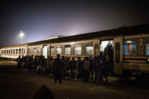 Migrants queue to board a train on the way to Slovenia at a makeshift train station within a temporary camp in Slavonski Brod, Croatia, Wednesday Nov. 4, 2015.  The weather is getting colder and many migrants are not equipped to cope with prolonged periods without shelter. (AP/Manu Brabo)