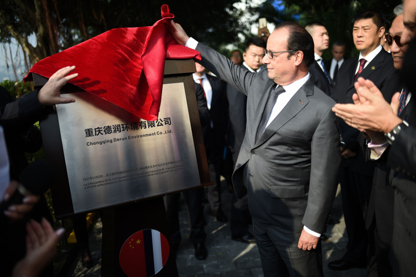 French President Francois Hollande unveils a plaque to inaugurate a new Sino French company to clean up grounds during a visit of the Sino French Tangjiatuo Wastewater treatment company in Chongqing on November 2, 2015. AFP PHOTO, STEPHANE DE SAKUTIN