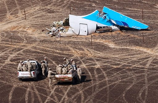 FILE - In this Sunday, Nov. 1, 2015 file photo provided by Russian Emergency Situations Ministry, Egyptian Military on cars approach a plane's tail at the wreckage of a passenger jet bound for St. Petersburg in Russia that crashed in Hassana, Egypt (Maxim Grigoriev/Russian Ministry for Emergency Situations via AP, File)