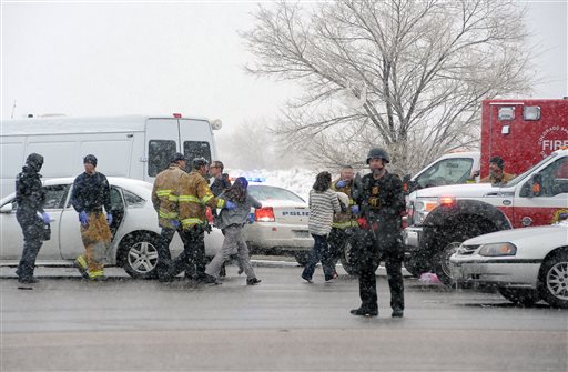 A woman is escorted by emergency personnel after reports of a shooting near the Planned Parenthood clinic Friday, Nov. 27, 2015, in Colorado Springs, Colo. (Daniel Owen/The Gazette via AP) 