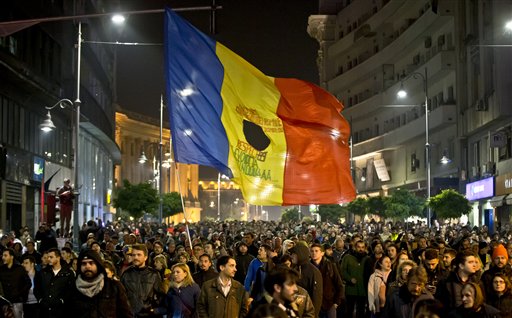 Romanians fill the Calea Victoriei, a main avenue of the Romanian capital, during a large protest in Bucharest, Romania, Tuesday, Nov. 3, 2015. More than 10,000 marched down the city's main boulevards and then massed outside the government offices Tuesday evening calling for the resignation of Prime Minister Victor Ponta, Interior Minister Gabriel Oprea and the mayor of the district where the Colectiv nightclub, the venue of a deadly fire last week, was located. (AP Photo/Vadim Ghirda)