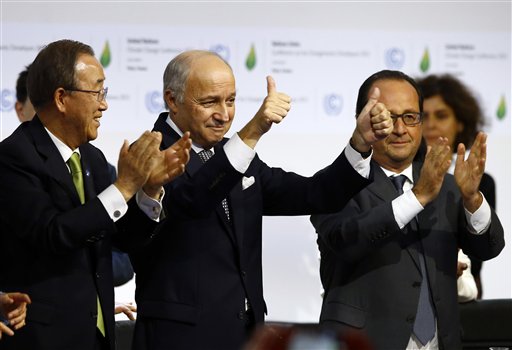 French foreign minister and President of the COP21 Laurent Fabius, center, applauds while United Nations Secretary General Ban Ki-moon, left, and French President Francois Hiollande applaud after the final conference of the COP21, the United Nations conference on climate change, in Le Bourget, north of Paris, Saturday, Dec.12, 2015. (AP Photo/Francois Mori)