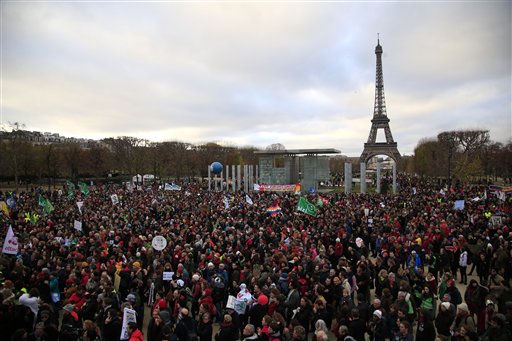 Activists gather near the Eiffel Tower, in Paris, Saturday, Dec.12, 2015 during the COP21, the United Nations Climate Change Conference. (AP Photo/Thibault Camus)
