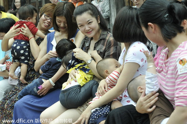 May 2014 photo taken in Fuzhou, Fujian province, shows women breastfeeding their babies in public, as part of an activity marking National Day of Breastfeeding - which falls on May 20 every year. This activity involved over 30 women who aimed to increase awareness of the benefits of breastfeeding for both baby and mother. (Photo/icpress.cn)