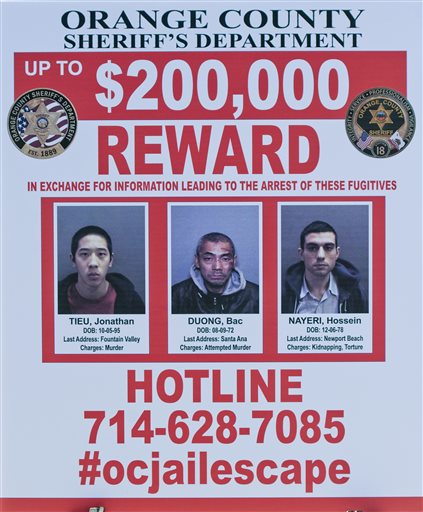 A wanted sign is displayed for the The reward for information leading to the arrest of the  the three escaped inmates from the Orange County Central Men's Jail on Tuesday, Jan. 26, 2016, in Santa Ana, Calif.  (Paul Rodriguez/The Orange County Register via AP)