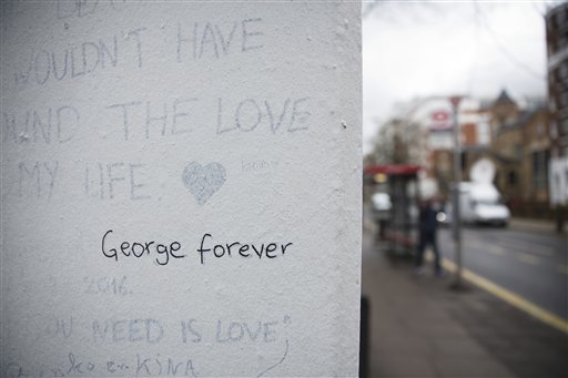 The words "George forever" are seen written on a wall outside Abbey Road studios where the Beatles recorded albums and where the zebra crossing cover picture of the Abbey Road album was originally taken in London, Wednesday, March 9, 2016. George Martin, the Beatles' urbane producer who quietly guided the band's swift, historic transformation from rowdy club act to musical and cultural revolutionaries, has died, his management said Wednesday March 9, 2016. He was 90. (AP Photo/Matt Dunham)