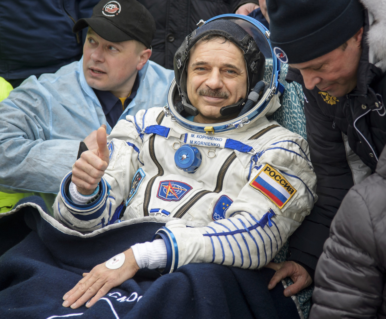 International Space Station (ISS) crew member Mikhail Kornienko of Russia gestures after landing near the town of Dzhezkazgan, Kazakhstan, Wednesday, March 2, 2016. U.S. astronaut Scott Kelly and Kornienko returned to Earth on Wednesday after spending almost a year in space in a ground-breaking experiment foreshadowing a potential manned mission to Mars. (Bill Ingalls/NASA via AP)