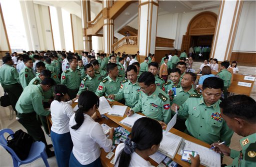 Appointed lawmakers who represent Myanmar's military mark their attendance for a parliamentary session in Naypyitaw, Myanmar, Monday, March 14, 2016. Myanmar's parliament vote on Tuesday, March 15 to pick the country's next president from a group of three final candidates, including a front runner who is a longtime confidant of Nobel laureate Suu Kyi. (AP Photo/Aung Shine Oo)