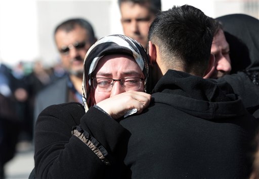 Family members of victims comfort each other outside the medical forensics site in Ankara, Turkey, Thursday, Feb. 18, 2016. A Syrian national with links to Syrian Kurdish militia carried out the suicide bombing in Ankara that targeted military personnel and killed at least 28 people, Turkey's prime minister said Thursday. Turkey's Kurdish rebels collaborated with the Syrian man to carry out Wednesday's attack, Ahmet Davutoglu said during a news conference. (AP Photo/Burhan Ozbilici)