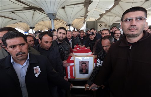 Family members and friends carry the Turkish flag-draped coffin of Murat Gul, 20, a security agent killed in Sunday's explosion during his funeral procession in Ankara, Turkey, Monday, March 14, 2016. A senior government official told The Associated Press that authorities believe the attack was carried out by two bombers, one of them a woman, and was the work of Kurdish militants. It was the second deadly attack blamed on Kurdish militants in the capital in the past month. (AP Photo/Burhan Ozbilici)