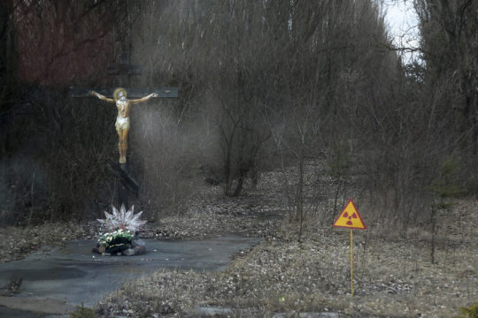 A crucifix and a radiation sign at the entrance to the out-of-bounds town Pripyat