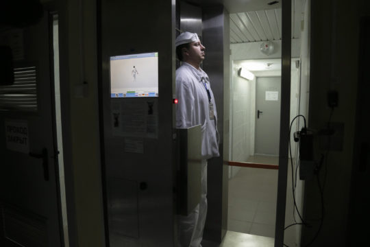 A worker checks radiation levels after he leaves the nuclear waste storage at the Chernobyl nuclear power plant
