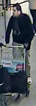In this image provided by the Belgian Federal Police in Brussels on Tuesday, March 22, 2016, a man suspected of taking part in the attacks at Belgium's Zaventem Airport and are being sought by police pushes a trolley in the airport terminal. The man has been the identified by the Federal Prosecutors office on Wednesday, March 23, 2016 as Ibrahim El Bakraoui. (Belgian Federal Police via AP)