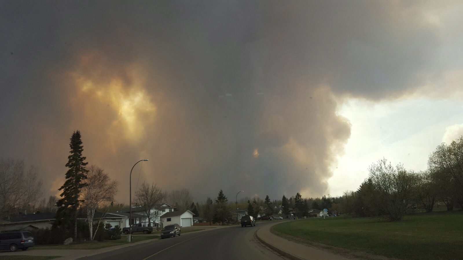 Smoke rises from a wildfire outside of Fort McMurray, Alberta, Tuesday, May 3, 2016. The entire population of the Canadian oil sands city of Fort McMurray, has been ordered to evacuate as a wildfire whipped by winds engulfed homes and sent ash raining down on residents. (Mary Anne Sexsmith-Segato/The Canadian Press via AP) MANDATORY CREDIT