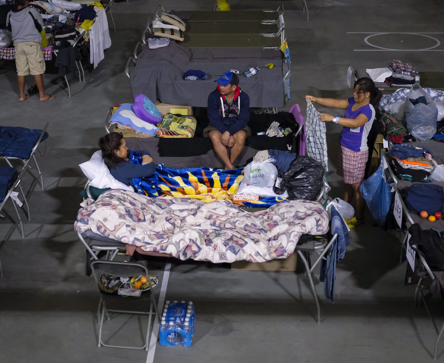 Evacuees from the Fort McMurray wildfires rest at the evacuation center in Lac la Biche, Alberta, Thursday, May 5, 2016. The Alberta government declared a province-wide fire ban in an effort to reduce the risk of more blazes in a province that is very hot and dry. The province of Alberta declared a state of emergency. (Jeff McIntosh/The Canadian Press via AP) MANDATORY CREDIT