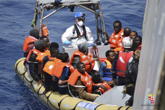 Migrants being rescued at sea by the Italian navy. 