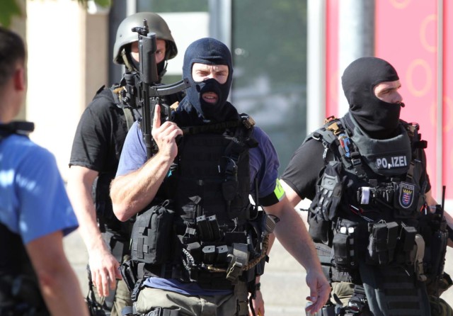 olicemen stand near a cinema where an armed man barricaded himself in Viernheim, southern Germany