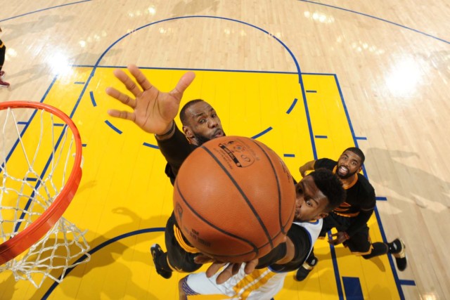 the Golden State Warriors shoots a lay up against LeBron James