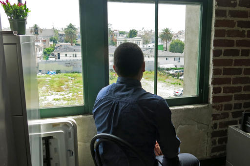 Jhonathan Rivas looks out the window on at the offices of the Central American Resource Center in Los Angeles, where a lawyer helped him prepare his application for asylum.