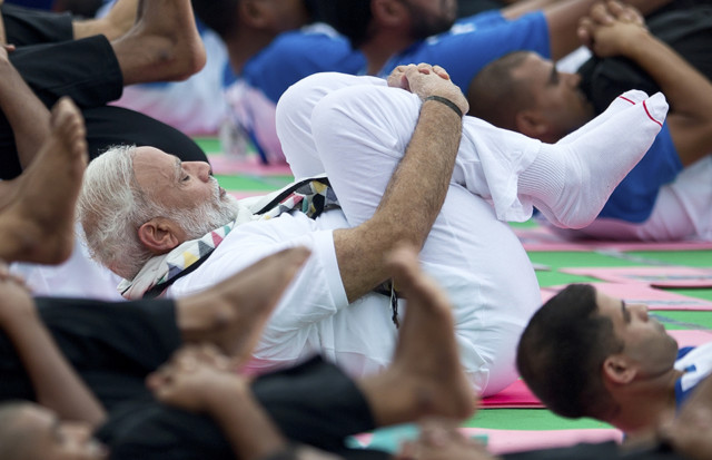 Indian Prime Minister Narendra Modi performs yoga along with thousands of Indians in Chandigarh, India, Tuesday, June 21, 2016. (AP Photo/Saurabh Das)