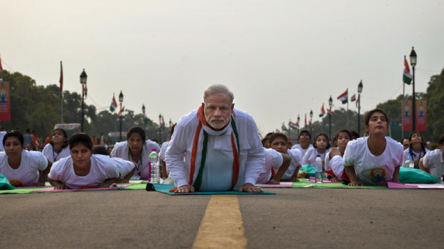 Prime Minister Narendra Modi performs yoga along with thousands of Indians on Rajpath, the mall of central New Delhi, for 2015 International Yoga Day. (Saurabh Das/AP)