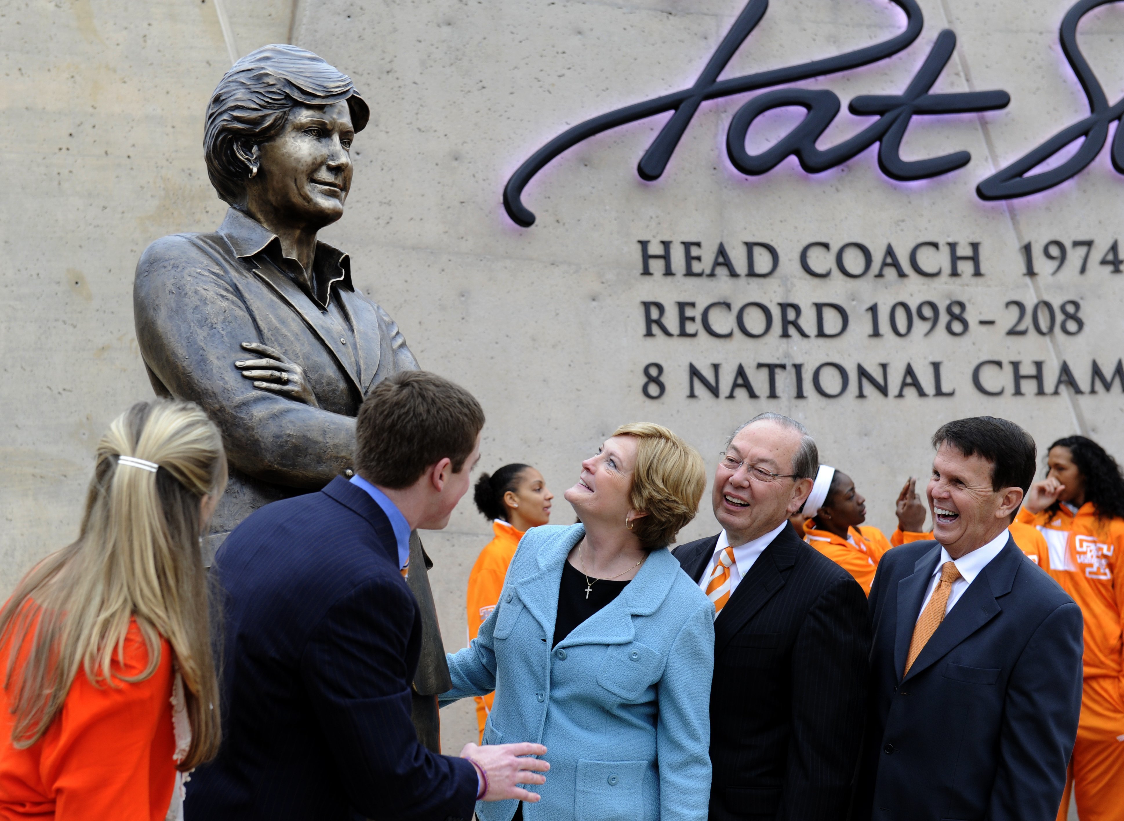 FILE - In this Nov. 22, 2013, file photo, Tennessee women's basketball coach emeritus Pat Summitt, center, looks at the statue unveiled in her honor, in Knoxville, Tenn. With Summitt are, from left, her daughter-in-law AnDe Summitt, son Tyler Summitt, UT Chancellor Jimmy Cheek, and director of athletics Dave Hart. Summitt, the winningest coach in Division I college basketball history who uplifted the women's game from obscurity to national prominence during her career at Tennessee, died Tuesday morning, June 28, 2016. She was 64. (Michael Patrick/Knoxville News Sentinel via AP) MANDATORY CREDIT