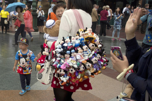 Visitors wear Mickey and Minnie Mouse memorabilia
