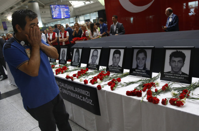 Family members, colleagues and friends of the victims of Tuesday blasts gather for a memorial ceremony at the Ataturk Airport in Istanbul, Thursday, June 30, 2016. (AP Photo/Emrah Gurel)