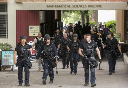Los Angeles Police officers walk by the Mathematical Sciences Building on the UCLA campus after a fatal shooting at the University of California, Los Angeles. (AP Photo/Damian Dovarganes)