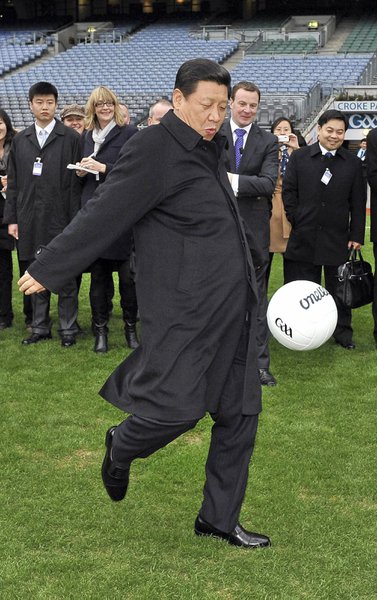 In this Feb. 19, 2012 file photo, Chinese Vice President Xi Jinping kicks a football during visit to Croke Park Stadium, Dublin, Ireland. China’s President Xi Jinping has collected titles ranging from National Security Council chief to good old “Uncle Xi.” Along the way, he’s used state media to make his views known on such seemingly apolitical topics as avant garde architecture and celebrity culture. (AP Photo/Brendan Moran/Pool, File)