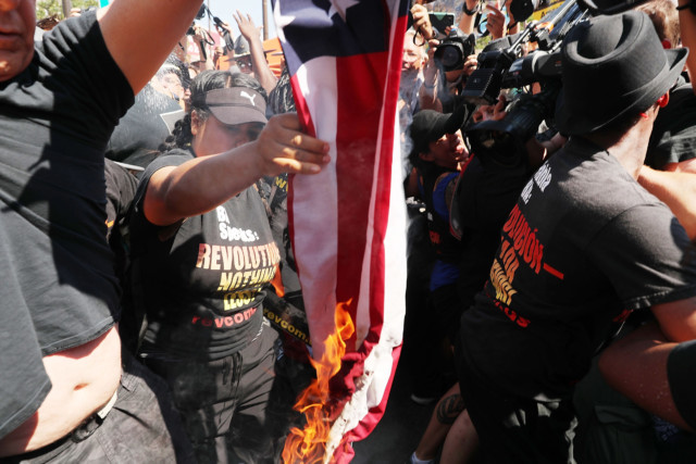 A group tries to burn an American Flag