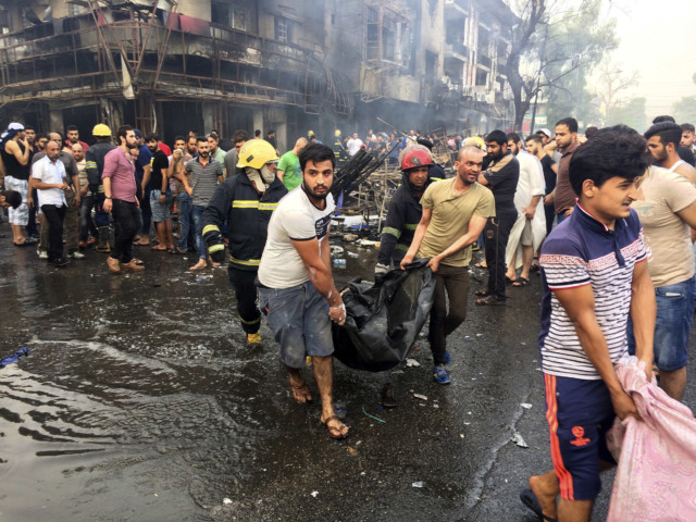 firefighters and civilians carry bodies