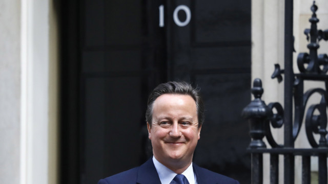 David Cameron smiles as he leaves 10 Downing Street