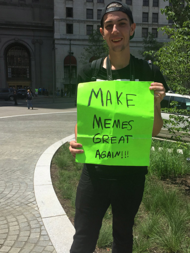 Boy with memes sign