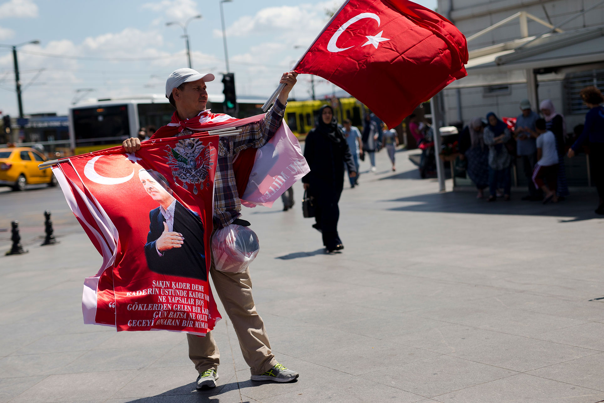 A street vendor sells flags, some showing Turkish President Recep Tayyip Erdogan in central Istanbul, Thursday, July 21, 2016. (AP Photo/Petros Giannakouris)