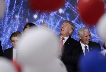 Donald Trump looks up at the falling balloons