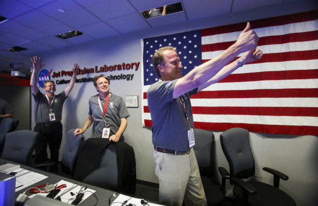 Michael Watkins, right, Scott Bolton, center, and Jim Green react in Mission Control at NASA's Jet Propulsion Laboratory as the solar-powered Juno spacecraft goes into orbit around Jupiter on Monday July 4, 2016 in Pasadena, Calif. (AP Photo/Ringo H.W. Chiu, Pool)