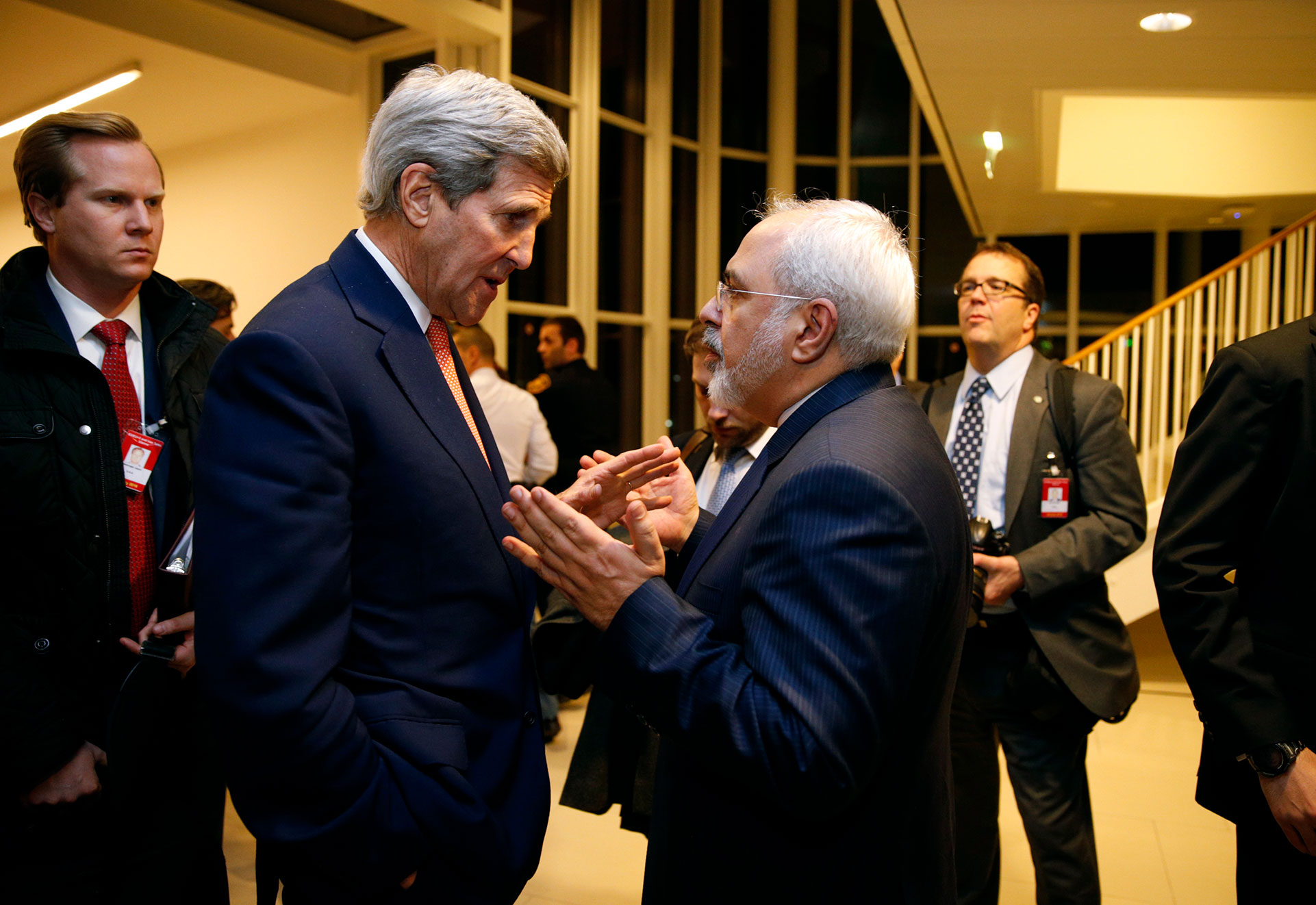 In this Jan. 16, 2016 file-pool photo, Secretary of State John Kerry talks with Iranian Foreign Minister Mohammad Javad Zarif in Vienna, after the International Atomic Energy Agency (IAEA) verified that Iran has met all conditions under the nuclear deal. The Iran nuclear accord is fragile at its one-year anniversary. (Kevin Lamarque/Pool via AP, File)