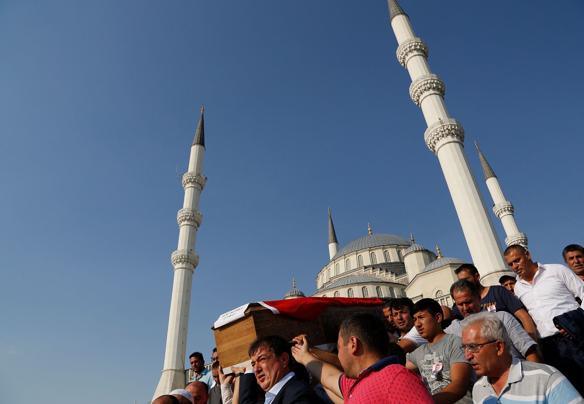 Turkish mourners carry the coffin of a policeman killed Friday during the failed military coup, during a mass funeral in Ankara, Turkey, Monday, July 18, 2016. (AP Photo/Hussein Malla)