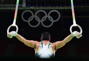 A Brazilian gymnast practices on the rings of the men's Artistic gymnastics during a practice session at the Olympic Arena