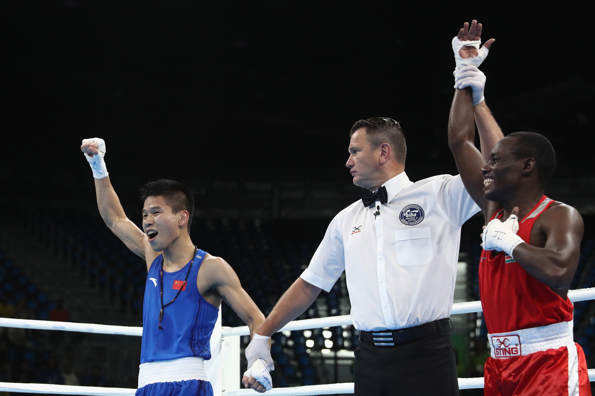 Lv Bin of China (L) and Peter Mungai Warui of Kenya (R) are awarded the decision in their Mens 46-49 Light Fly Weight bout on Day 3 of the Rio 2016 Olympic Games at the Riocentro - Pavilion 6 on August 8, 2016 in Rio de Janeiro, Brazil. (Photo by Phil Walter/Getty Images, via VCG)