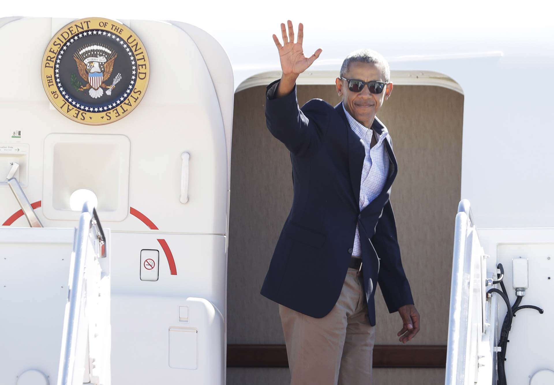 President Barack Obama waves as he boards the Air Force One at Andrews Air Force Base, Md., Tuesday, Aug. 23, 2016, for a trip to Baton Rouge, La. Obama is traveling to Baton Rouge, La., where he will get a first-hand look at the impact of the devastating floods on the community. (AP Photo/Manuel Balce Ceneta)