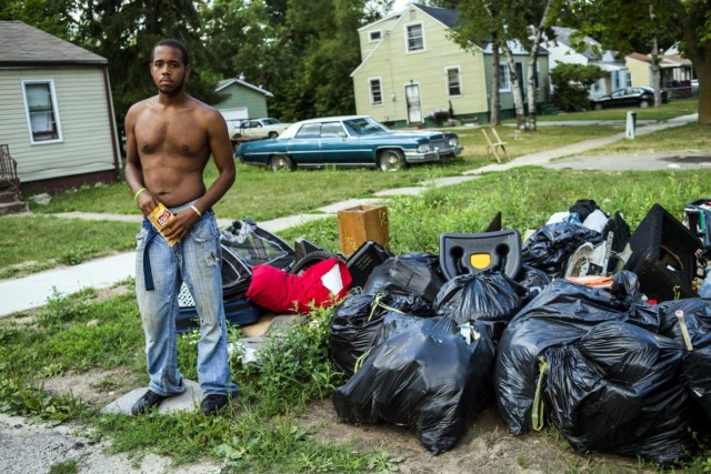 Kevin Ditto, 24, who lives on Dupont Street on Flint's north side, is disgusted with city officials' decision to cease trash collection on Monday, Aug. 1, 2016. Officials reached a temporary agreement to have trash collected through Aug. 12, starting Tuesday, Aug 2. No trash was picked up on Monday. "I've been waiting all morning for them to help them load some of this trash on the truck," said Ditto, who moved into the home last week and from Georgia one year ago. "I'm ready to head back south if I can convince my wife to move." (PHOTO: Jake May | MLive.com)