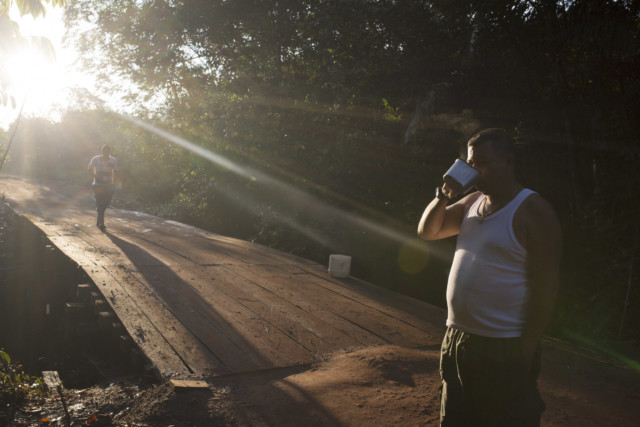 A rebel of the Revolutionary Armed Forces of Colombia, FARC, drinks coffee in a camp in the Yari Plains of southern Colombia, Monday, Sept. 26, 2016. Colombia will take a big step toward emerging from its long history of violence Monday when the government and the country's largest rebel movement sign a peace accord that emerged from four hard years of negotiations. (AP Photo/Ricardo Mazalan)